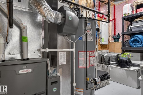 The property includes a water heater and a Lennox furnace, ensuring comfort and convenience - 26 Edgewater Terr N, St. Albert, AB - Indoor Photo Showing Basement