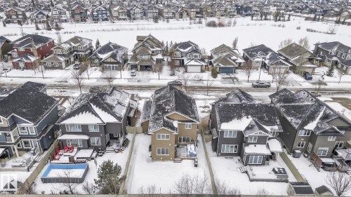 This property features a fenced backyard with a pool, a patio area, and a shed - 26 Edgewater Terr N, St. Albert, AB - Outdoor With Facade