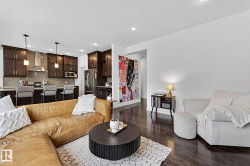 Open concept living area featuring dark hardwood flooring and recessed lighting - 26 Edgewater Terr N, St. Albert, AB - Indoor Photo Showing Living Room