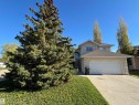 Two-story stucco residence featuring an attached double garage, a concrete driveway, and an arched entry with an overhead window - 3516 49 Avenue, Drayton Valley, AB  - Outdoor 