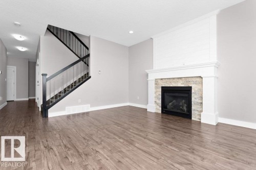 62 Ellice Bend, Fort Saskatchewan, AB - Indoor Photo Showing Living Room With Fireplace