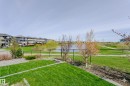 Expansive green space featuring a water body, walking path, and mature trees - 62 Ellice Bend, Fort Saskatchewan, AB  - Outdoor With View 