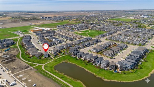 Aerial perspective showcasing a developed residential neighborhood with a central location marker - 62 Ellice Bend, Fort Saskatchewan, AB - Outdoor With View