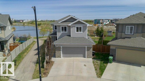 Contemporary two-story residence featuring grey siding and stone veneer accents - 62 Ellice Bend, Fort Saskatchewan, AB - Outdoor