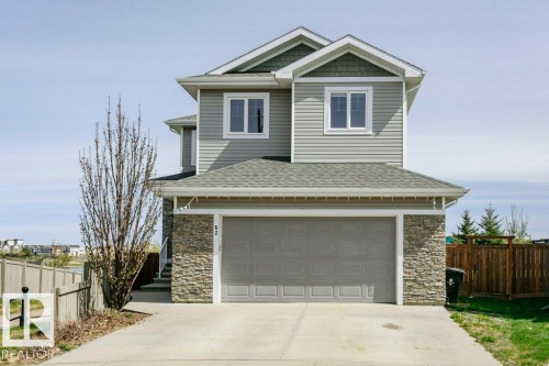 Contemporary two-story residence featuring light gray siding and stone facade detailing - 62 Ellice Bend, Fort Saskatchewan, AB - Outdoor