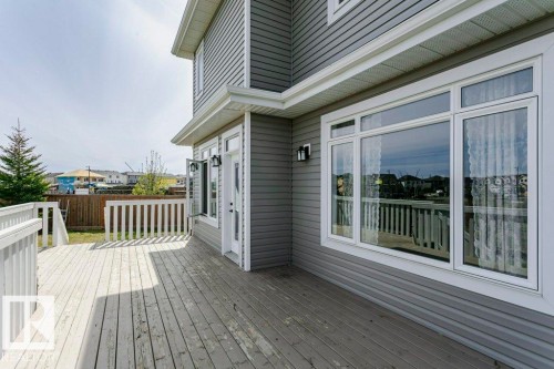Spacious wood deck with white painted railings and direct access to the interior - 62 Ellice Bend, Fort Saskatchewan, AB - Outdoor With Deck Patio Veranda With Exterior