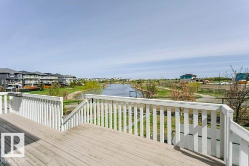 Spacious outdoor deck with white painted railings and direct water frontage - 62 Ellice Bend, Fort Saskatchewan, AB - Outdoor With Deck Patio Veranda