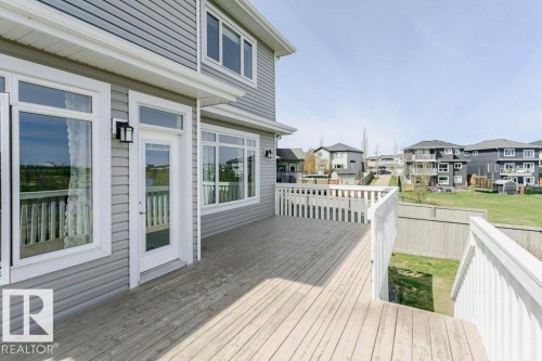 Spacious outdoor deck featuring natural wood-finish flooring and white railing - 62 Ellice Bend, Fort Saskatchewan, AB - Outdoor With Deck Patio Veranda