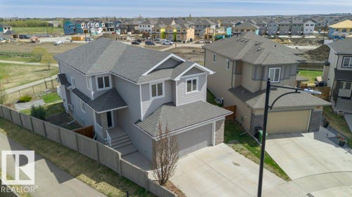 Two-story residence featuring light gray siding and a dark gray shingle roof - 62 Ellice Bend, Fort Saskatchewan, AB - Outdoor