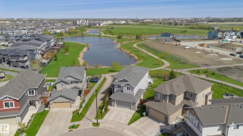 Aerial perspective showcasing a residential development with water features and green spaces - 62 Ellice Bend, Fort Saskatchewan, AB - Outdoor With View