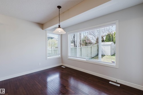 Spacious interior with dark wood-finish flooring - 1140 115 Street, Edmonton, AB - Indoor Photo Showing Other Room