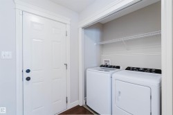 Dedicated laundry area featuring a wire shelf and connections for appliances - 