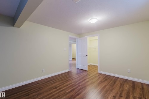 Bright interior space featuring wood-finish flooring, light-toned walls, and white trim - 1140 115 Street, Edmonton, AB - Indoor Photo Showing Other Room