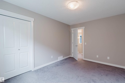 Neutral-toned room with plush grey carpet and white baseboards - 7827 18 Avenue, Edmonton, AB - Indoor Photo Showing Other Room