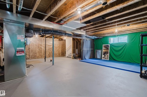 Unfinished basement offering expansive open space, exposed ceiling joists, and a concrete floor - 7827 18 Avenue, Edmonton, AB - Indoor Photo Showing Basement