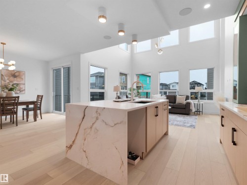 Open-concept living space featuring light wood-finish flooring throughout - 43 Eldridge Point(E), St. Albert, AB - Indoor