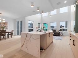 Open-concept living space featuring light wood-finish flooring throughout - 