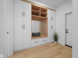 Built-in storage solutions featuring white cabinetry and light wood-finish accents - 