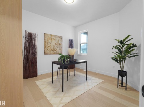 Light wood-finish flooring complements crisp white walls - 43 Eldridge Point(E), St. Albert, AB - Indoor Photo Showing Other Room