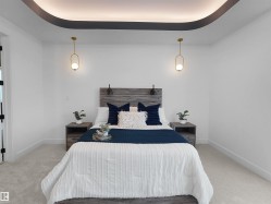 Recessed tray ceiling with cove lighting and two gold-finish pendant light fixtures - 