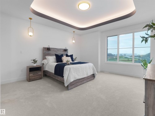 Recessed ceiling design with cove lighting and a central flush mount fixture - 43 Eldridge Point(E), St. Albert, AB - Indoor Photo Showing Bedroom