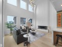 Two-story living area with high ceilings, light wood-finish flooring, and multiple large windows - 43 Eldridge Point(E), St. Albert, AB  - Indoor With Fireplace 