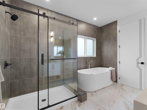 Walk-in shower with a frameless glass enclosure and black hardware - 43 Eldridge Point(E), St. Albert, AB - Indoor Photo Showing Bathroom
