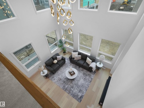 Two-story living area featuring a vaulted ceiling and an ornate chandelier - 43 Eldridge Point(E), St. Albert, AB - Indoor Photo Showing Other Room