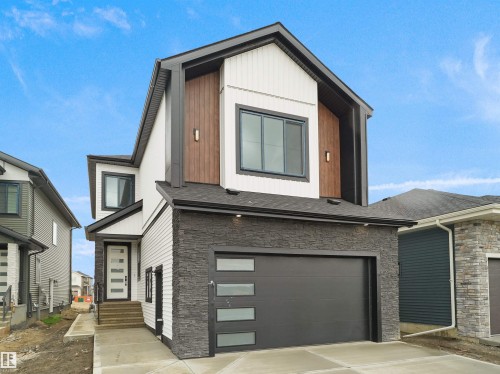 Contemporary exterior featuring black stacked stone, white horizontal siding, and wood-finish paneling - 43 Eldridge Point(E), St. Albert, AB - Outdoor