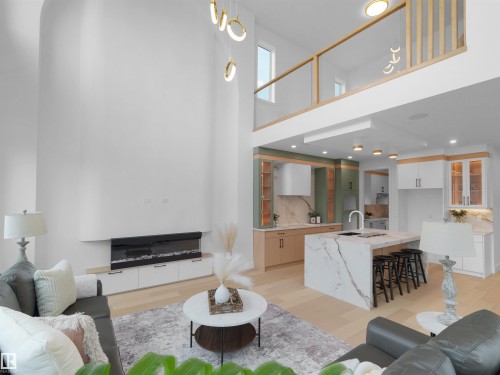 Spacious living area featuring a double-height ceiling, built-in electric fireplace, and light wood-finish flooring - 43 Eldridge Point(E), St. Albert, AB - Indoor Photo Showing Living Room