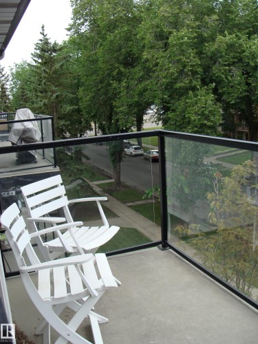 Private balcony with a concrete floor and modern glass railing - 401 10326 117 Street, Edmonton, AB - Outdoor
