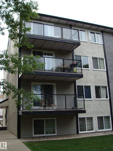 Multi-level residential building featuring private balconies with glass panel railings - 401 10326 117 Street, Edmonton, AB - Outdoor With Balcony