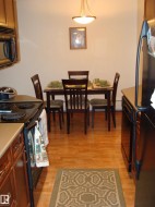 Kitchen and dining area featuring wood-finish flooring - 