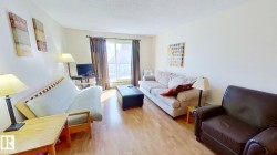Living area featuring light wood-finish flooring and neutral wall tones - 