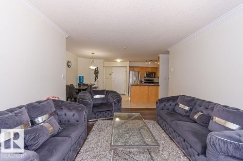 Open concept living area with wood-finish flooring - 214 13005 140 Avenue, Edmonton, AB - Indoor Photo Showing Living Room