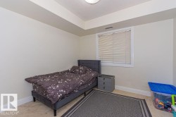 Interior space featuring neutral wall paint, carpet flooring, a window with blinds, and white trim - 