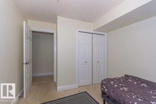 Room featuring neutral-toned walls, white trim, and carpeted flooring - 214 13005 140 Avenue, Edmonton, AB - Indoor Photo Showing Bedroom