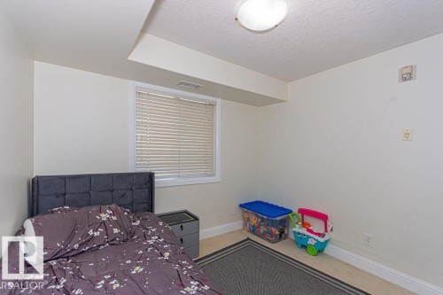 Room with a window featuring horizontal blinds, a white trim, and a built-in ceiling light fixture - 214 13005 140 Avenue, Edmonton, AB - Indoor Photo Showing Other Room