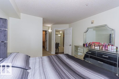 Interior space with light-toned walls and carpet flooring - 214 13005 140 Avenue, Edmonton, AB - Indoor Photo Showing Bedroom