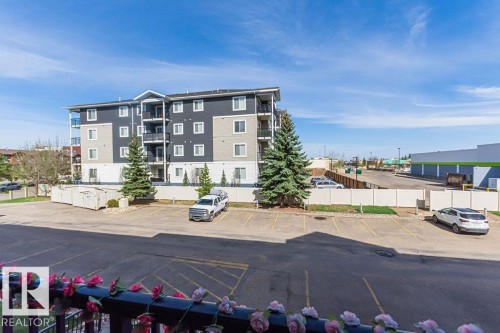 Multi-story building featuring a contemporary facade with dark gray and light beige siding - 214 13005 140 Avenue, Edmonton, AB - Outdoor