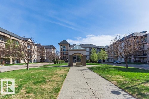 Landscaped common area featuring a paver walkway and central gazebo with a glass roof - 214 13005 140 Avenue, Edmonton, AB - Outdoor With Facade