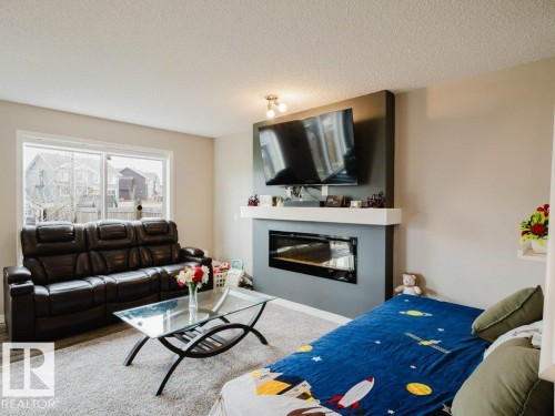 7607 24 Avenue, Edmonton, AB - Indoor Photo Showing Living Room With Fireplace