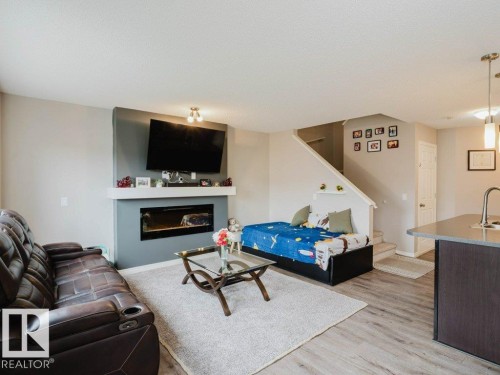 7607 24 Avenue, Edmonton, AB - Indoor Photo Showing Living Room With Fireplace