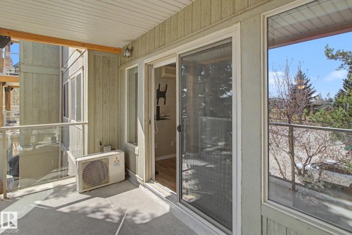 Outdoor patio with a concrete surface and glass railing - 204 278 Suder Greens Drive, Edmonton, AB - Outdoor With Balcony With Exterior