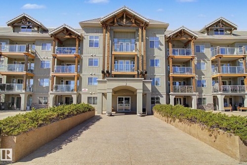 Multi-story residential building featuring multiple private balconies with glass railings - 204 278 Suder Greens Drive, Edmonton, AB - Outdoor With Balcony With Facade