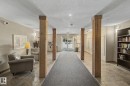 Central hallway with wood pillars and tile flooring - 204 278 Suder Greens Drive, Edmonton, AB  - Indoor Photo Showing Other Room 