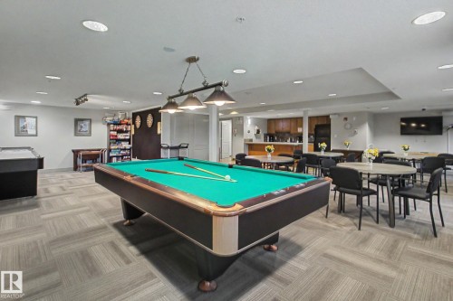 Recreation room featuring a billiards table, geometric carpet flooring, recessed lighting, and a full-service kitchen area - 204 278 Suder Greens Drive, Edmonton, AB - Indoor Photo Showing Other Room