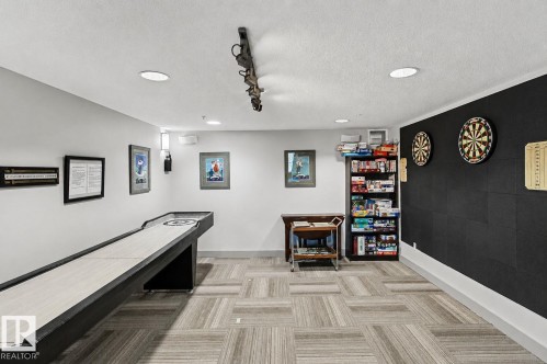 Recreation room featuring a shuffleboard table, recessed lighting, and patterned carpet tile flooring - 204 278 Suder Greens Drive, Edmonton, AB - Indoor Photo Showing Other Room