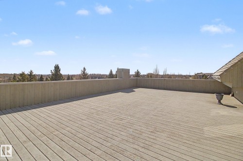 Expansive rooftop deck featuring composite decking and a solid perimeter wall - 204 278 Suder Greens Drive, Edmonton, AB - Outdoor