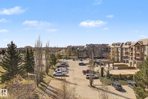 Multi-story residential buildings featuring gabled roofs and individual balconies - 204 278 Suder Greens Drive, Edmonton, AB - Outdoor With View